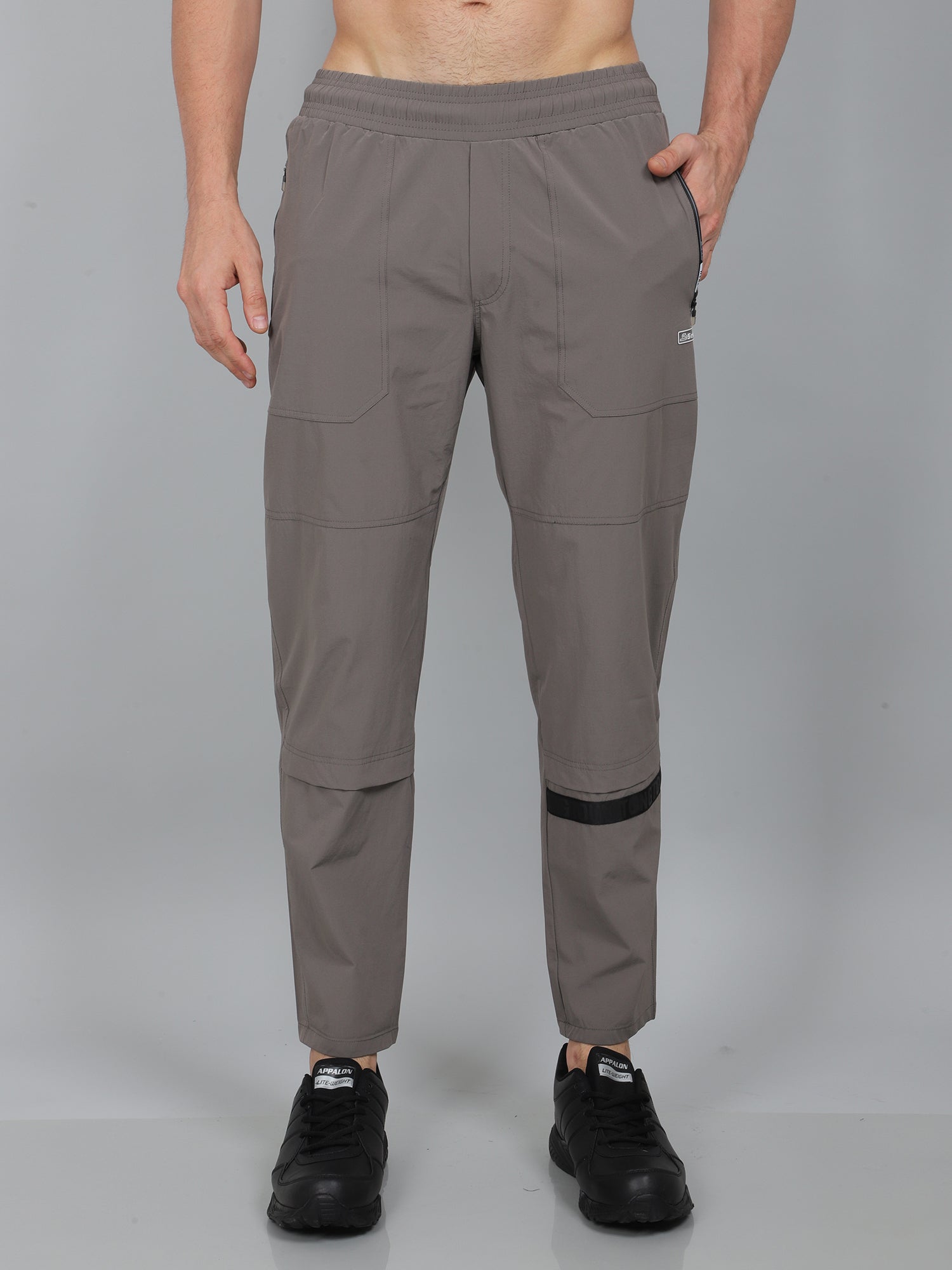 Person wearing gray pants on a gray background