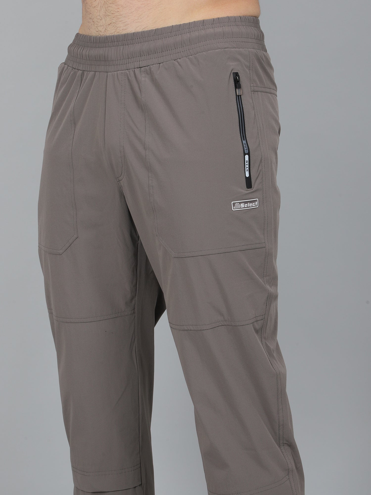 Brown pants with a visible brand logo on a gray background