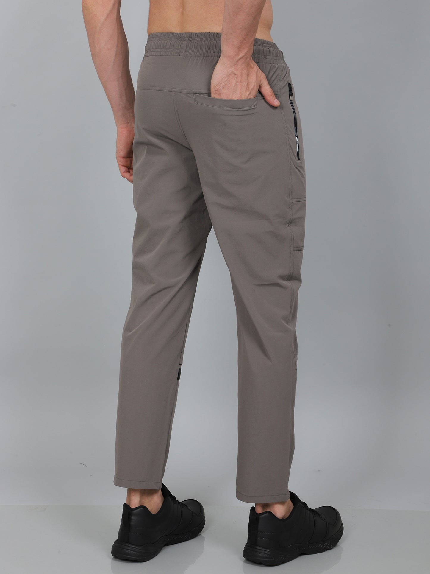 Person wearing gray pants on a plain background