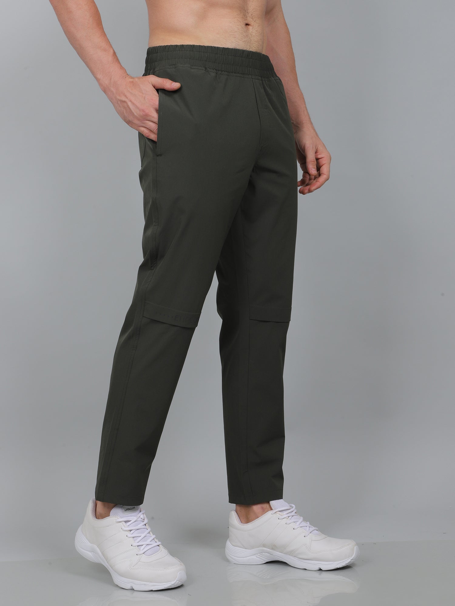 Person wearing black pants with a white background