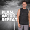 Man in athletic wear with 'PLAN. WORK. REPEAT.' text against a road and mountain backdrop