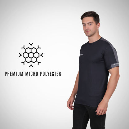 Man wearing a black athletic shirt with a logo and text on a white background