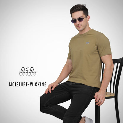 Man wearing a green t-shirt sitting on a chair with 'Moisture-Wicking' text and logo.