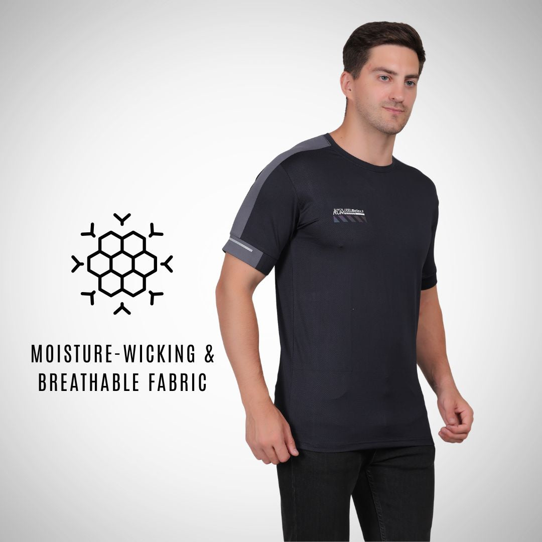 Man wearing a black athletic shirt with gray sleeves, standing against a white background.