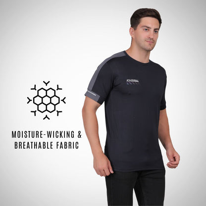 Man wearing a black athletic shirt with gray sleeves, standing against a white background.