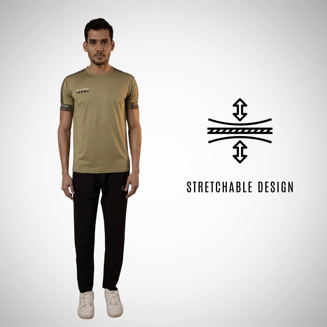 Person wearing a beige t-shirt and black pants with a stretchable design icon on a white background