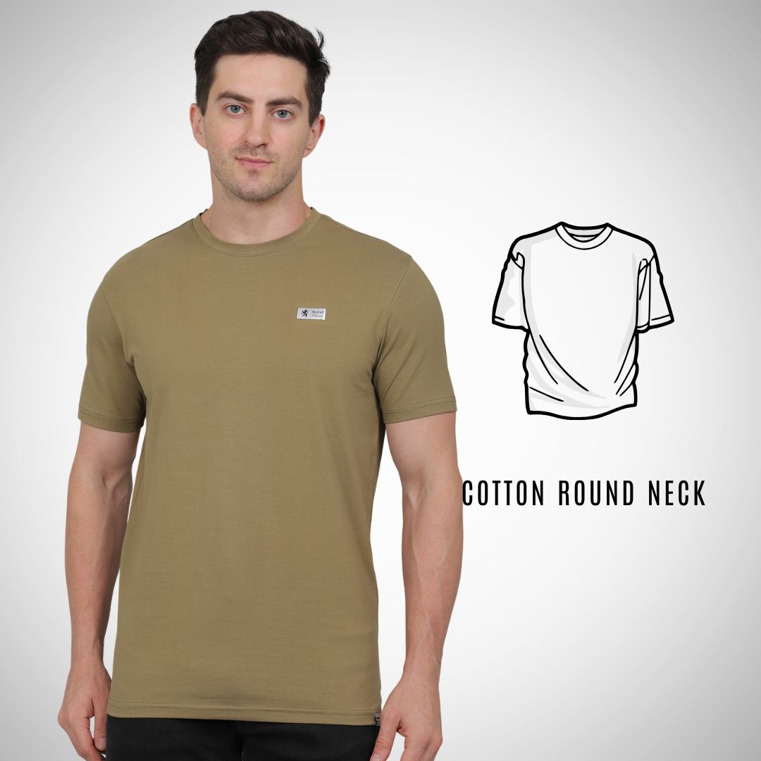 Man wearing a green t-shirt with a small logo on a white background