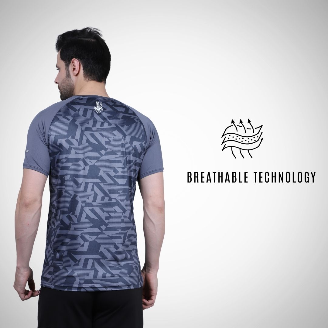 Person wearing a gray patterned t-shirt with breathable technology label on a white background