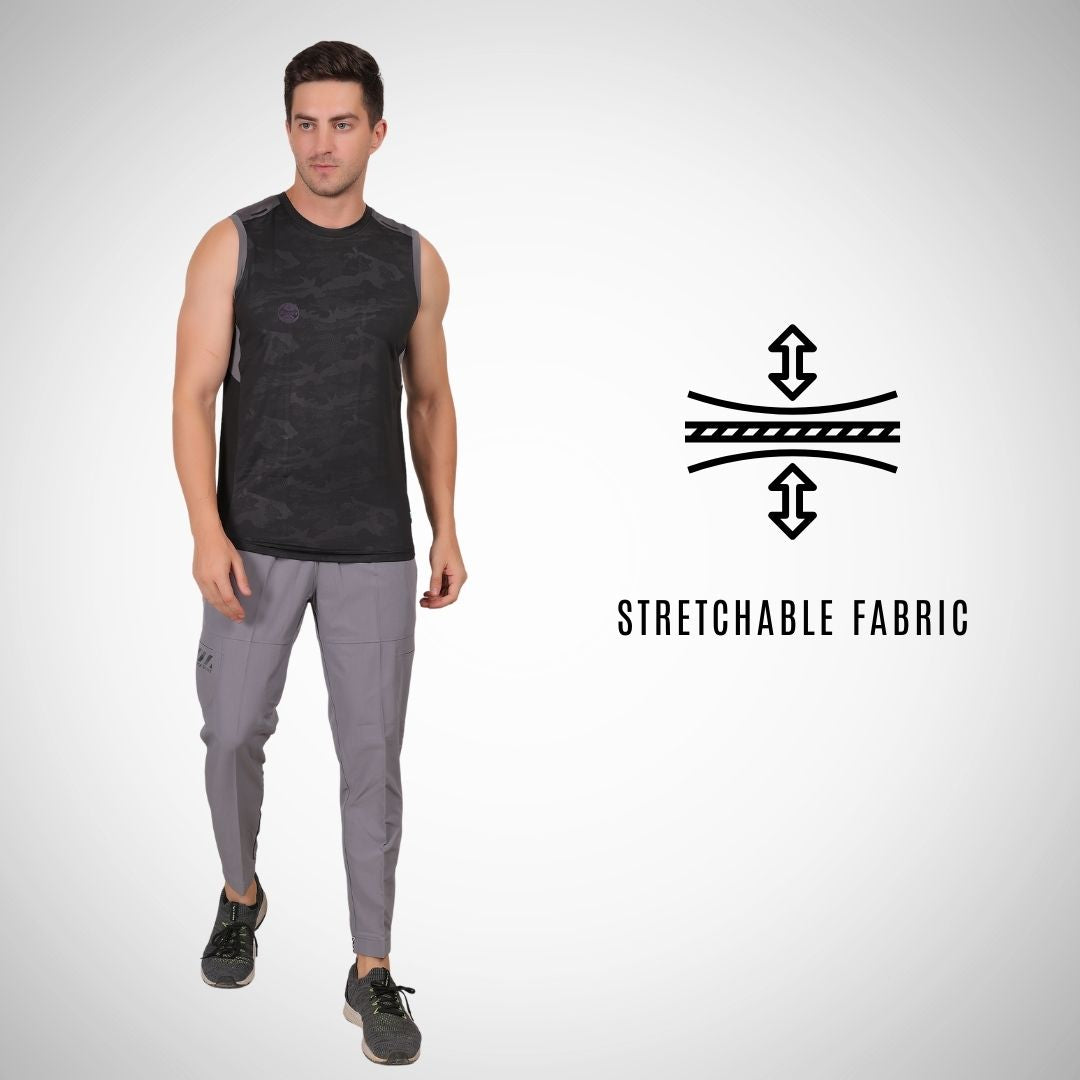 Man wearing a black sleeveless shirt and gray pants with a stretchable fabric icon and text on a white background.