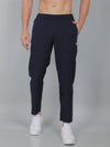Person wearing navy blue jogger pants on a gray background