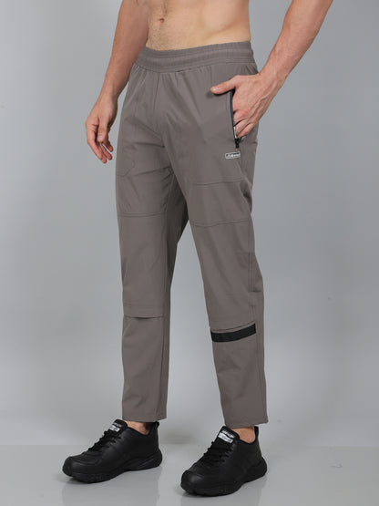 Person wearing gray pants with a visible brand logo on a gray background