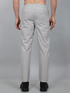 Person wearing light gray pants on a plain background