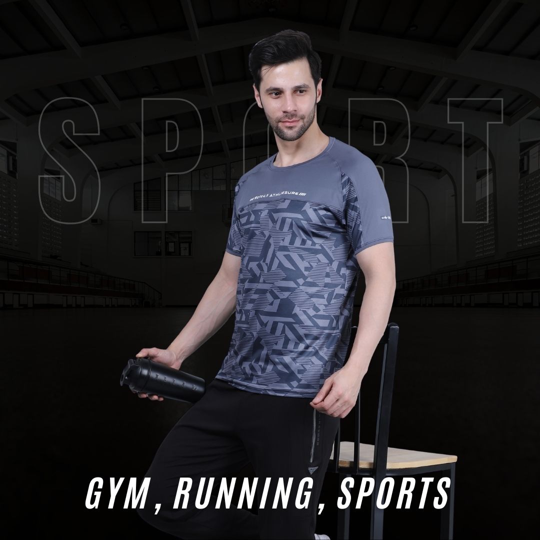 Man wearing a patterned t-shirt sitting on a bench with gym equipment in the background